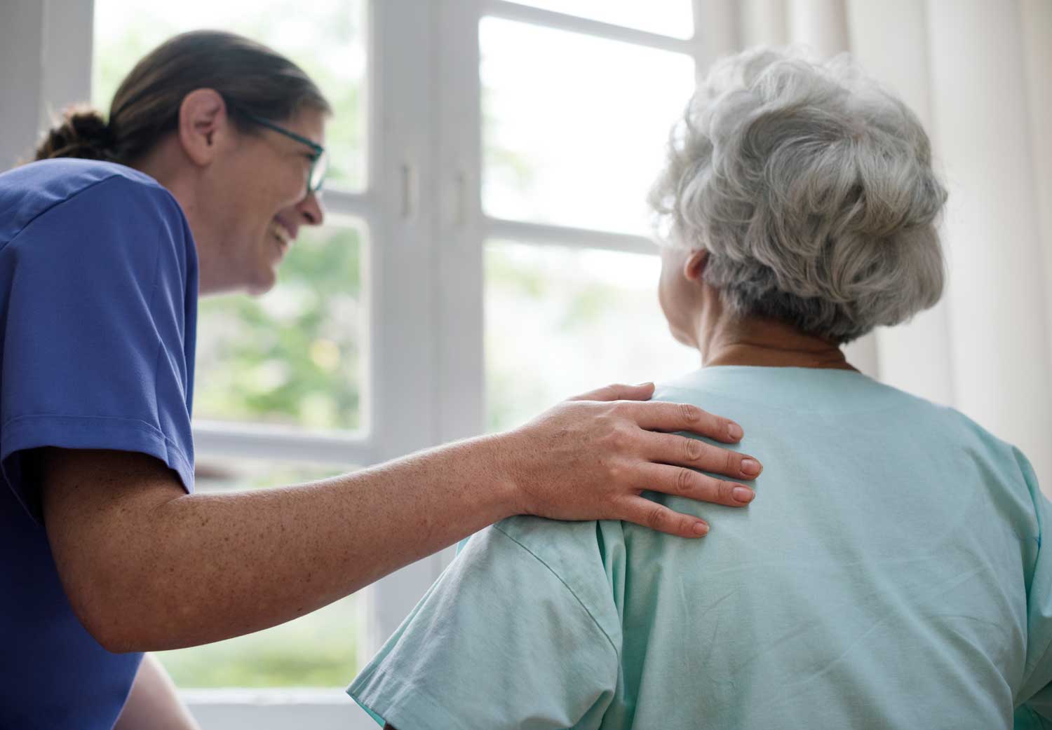 Care professional sharing a warm moment with a service user